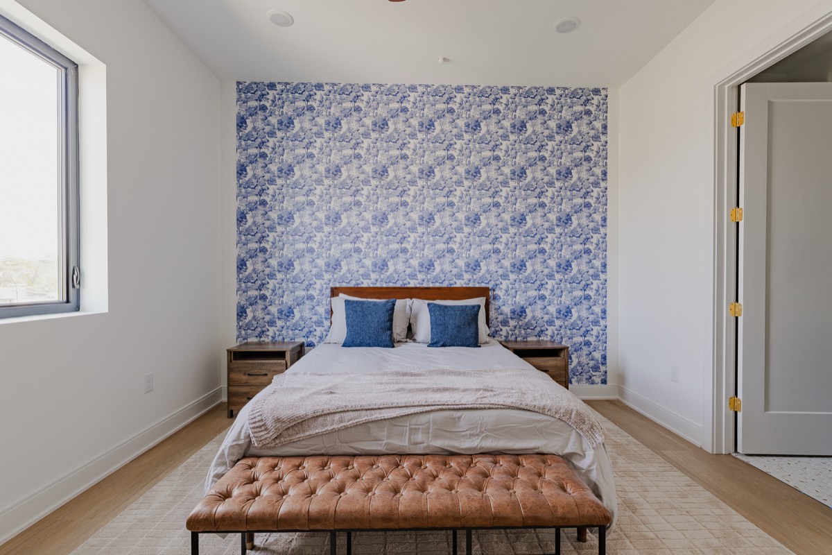 Primary bedroom with blue feature wall inside Hayden Mansion